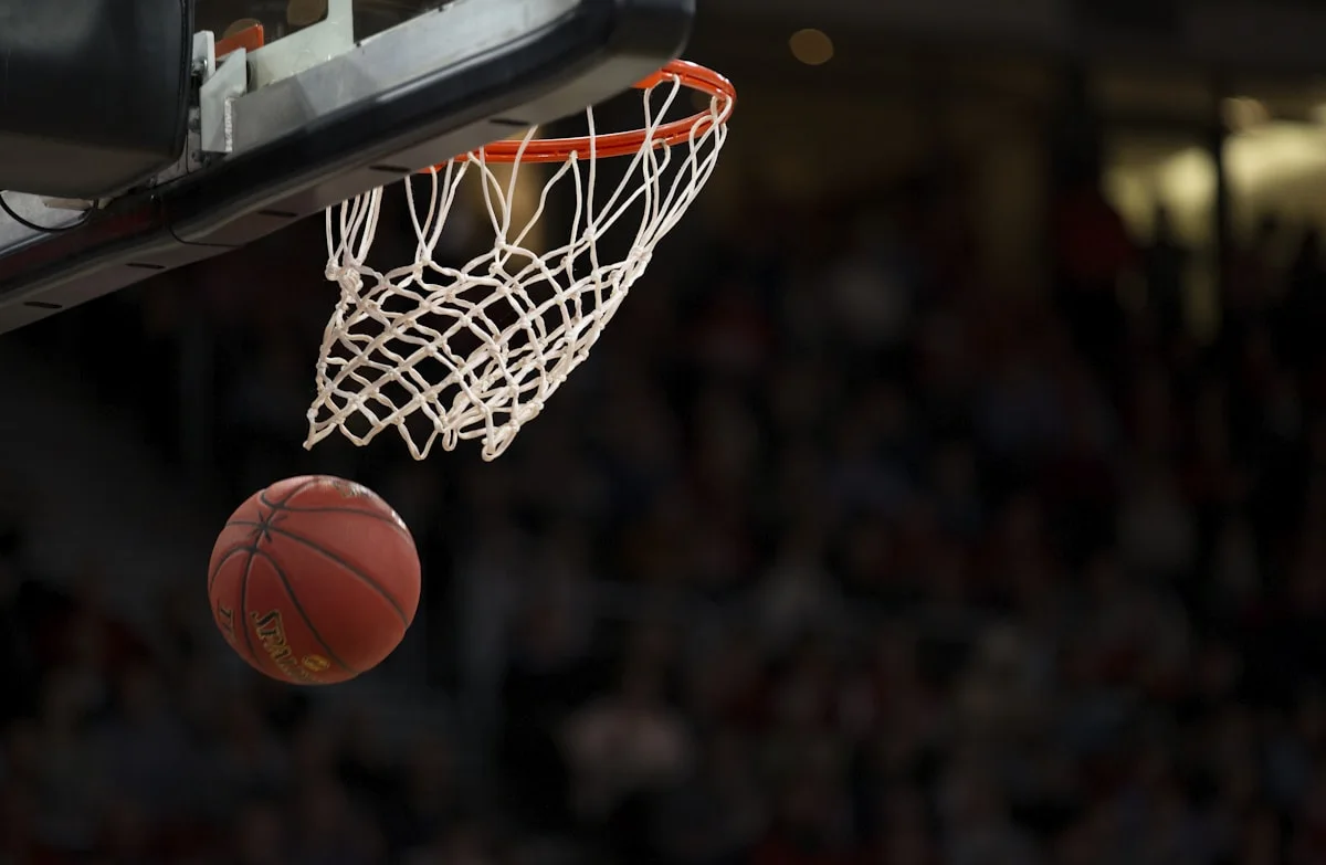 Basketball dropping through a court net